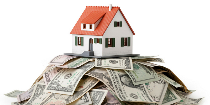 Image of a house on a pile of money.