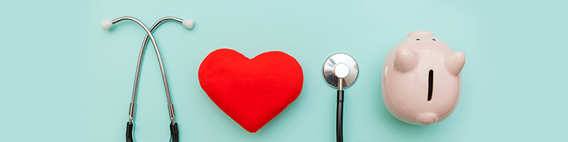 Image of a red heart, stethoscope, and piggy bank