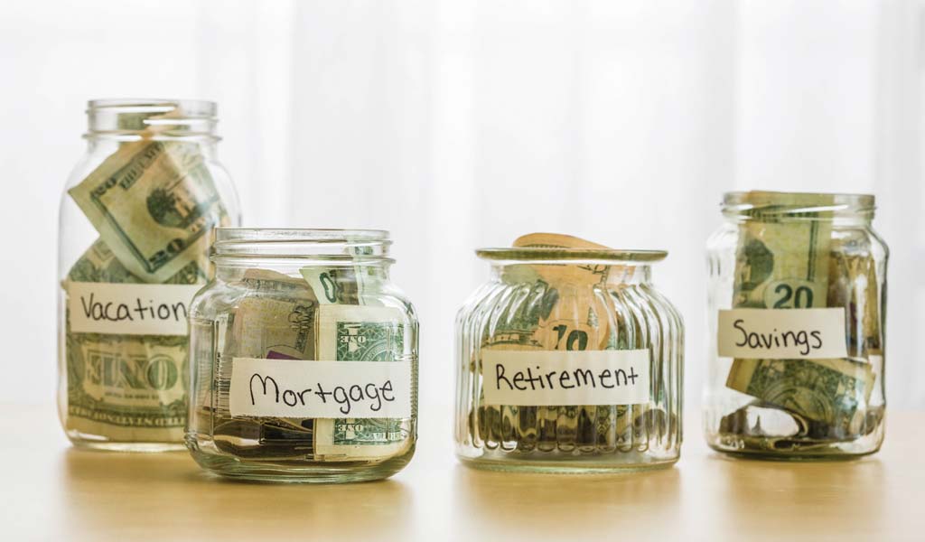 Image of mason jars with money inside depicting different savings categories.