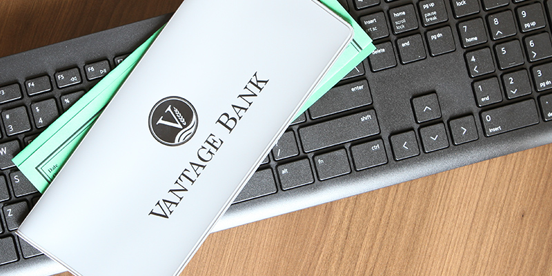 Image of a Vantage Bank CD sleeve and a keyboard