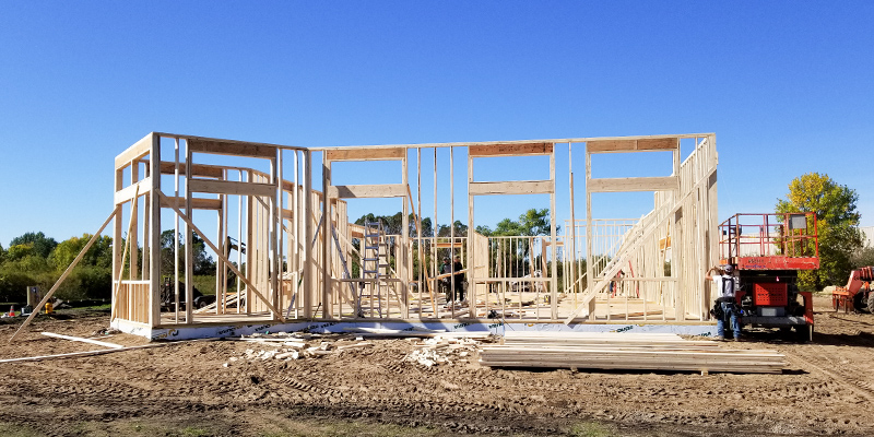 Construction work zone with building framed out.